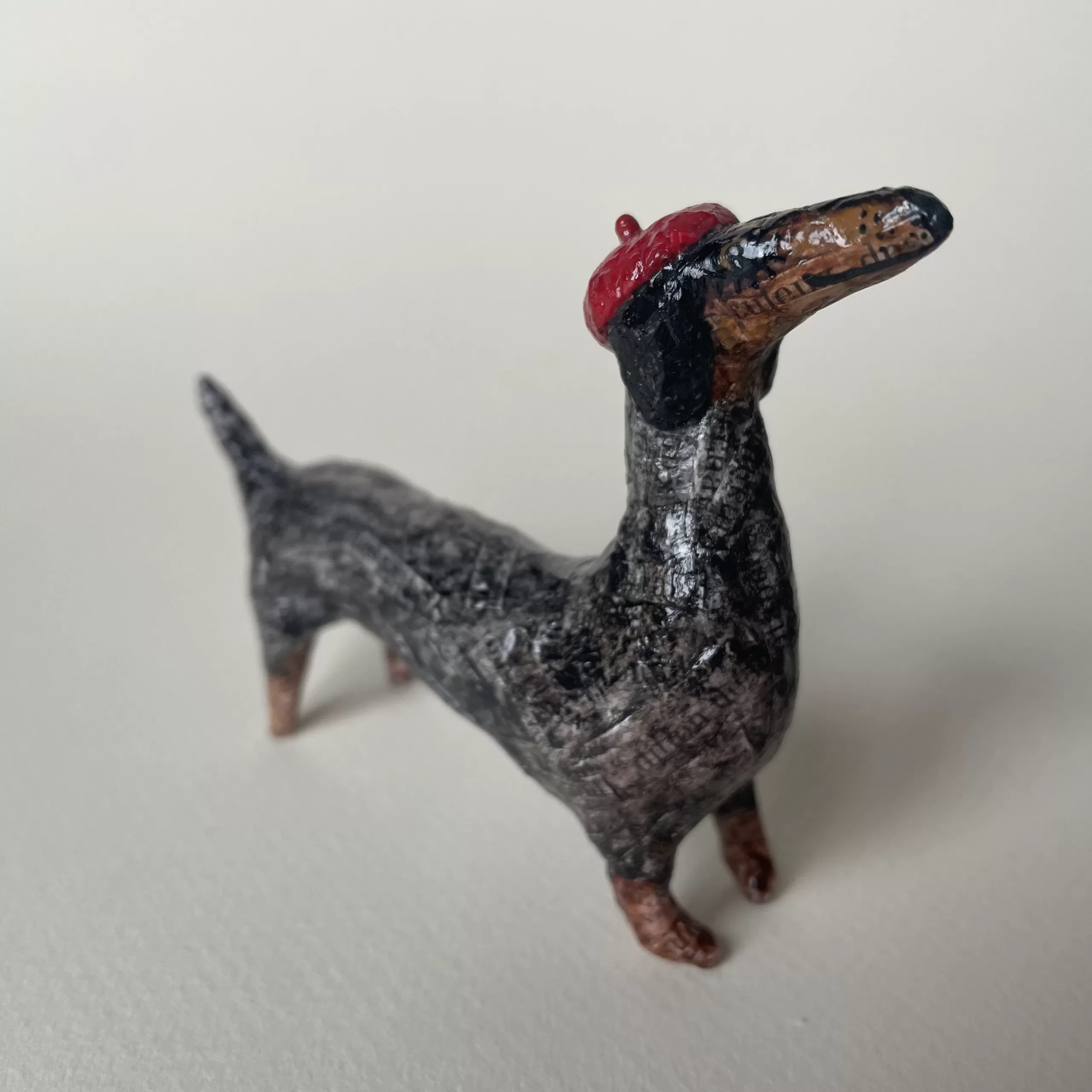 Paper mache miniature figurine of dachshund