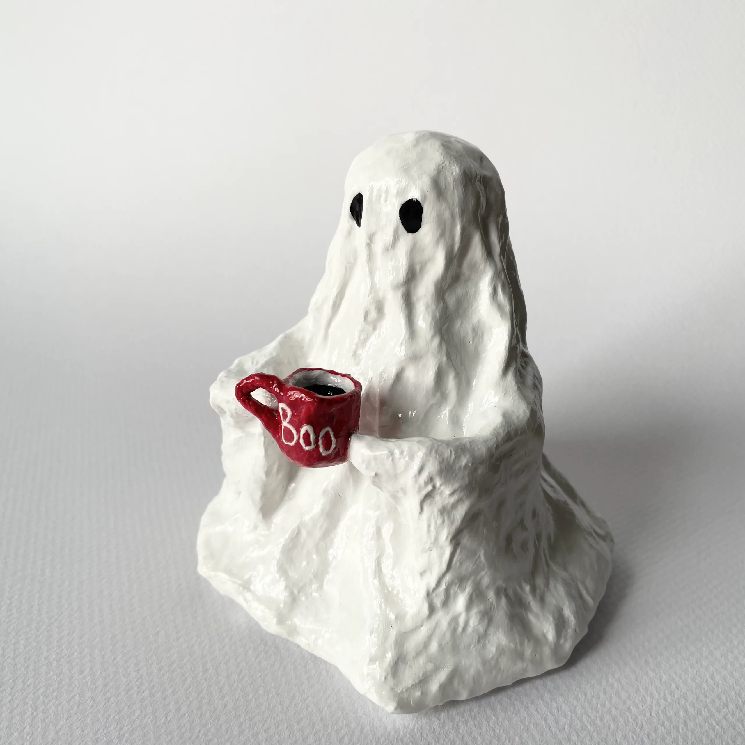 Ghost holding a cup of coffee handmade paper mache figurine